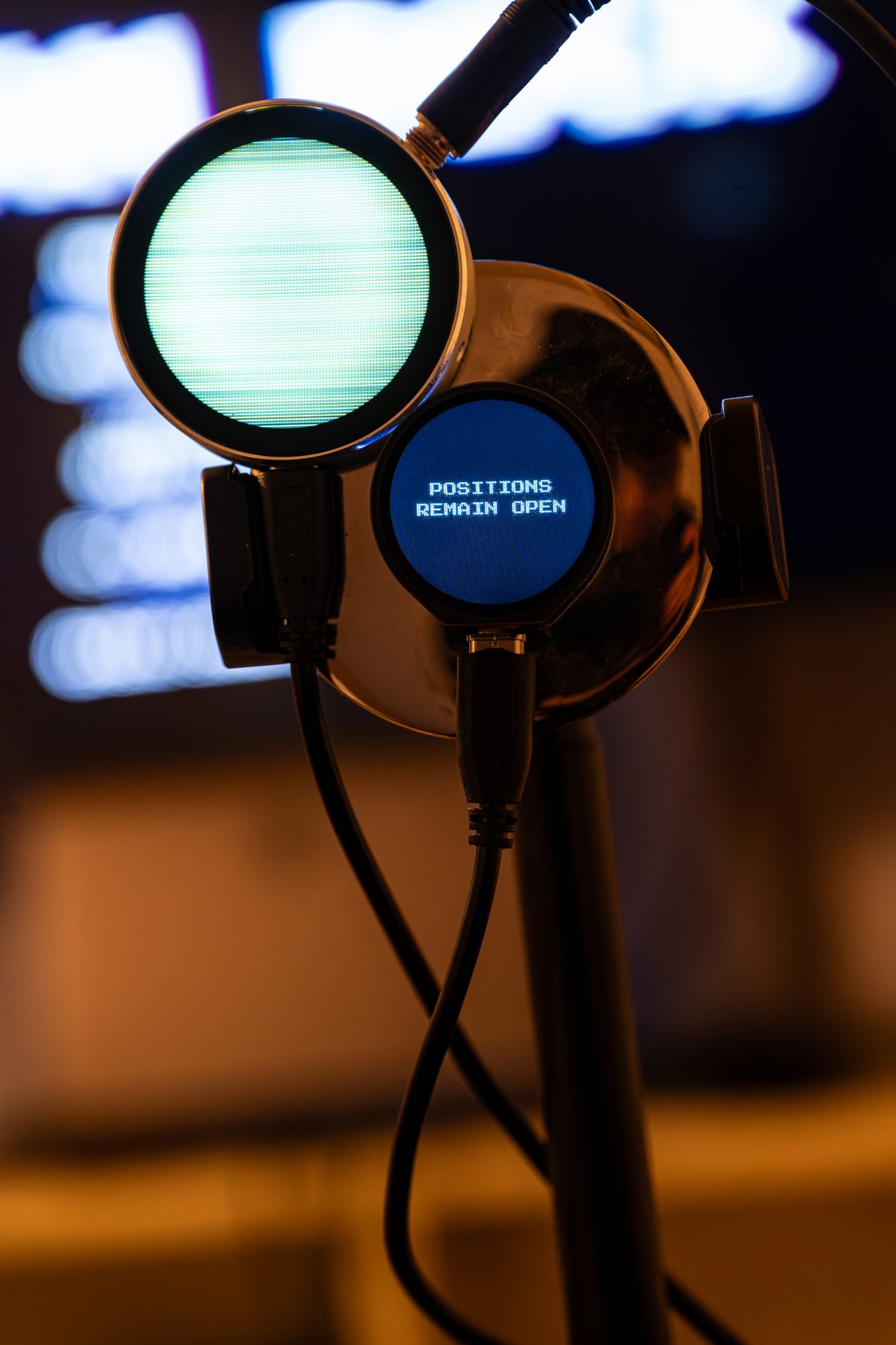 Close-up: POSITIONS REMAIN OPEN on the round caption terminal