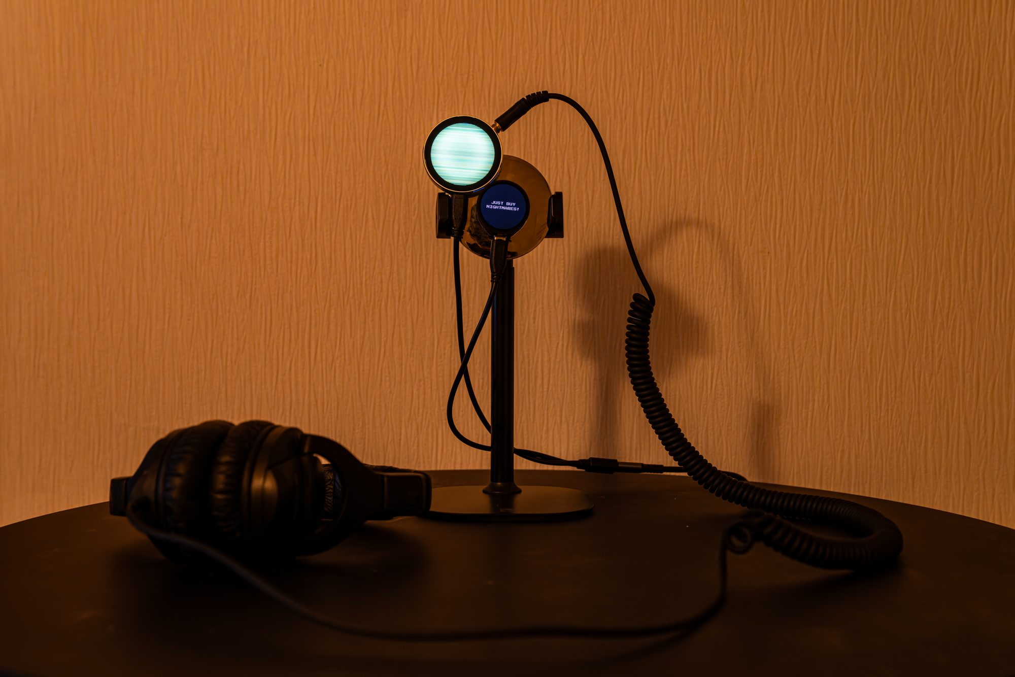 Two round terminals and headphones on a table